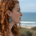 Close up of model wearing blue purple baroque pearl earring