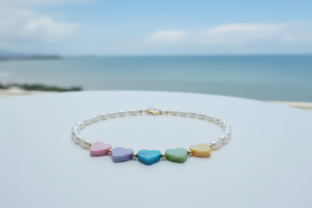 White freshwater rice pearl necklace with pastel rainbow heart charms and gold plated lobster clasp